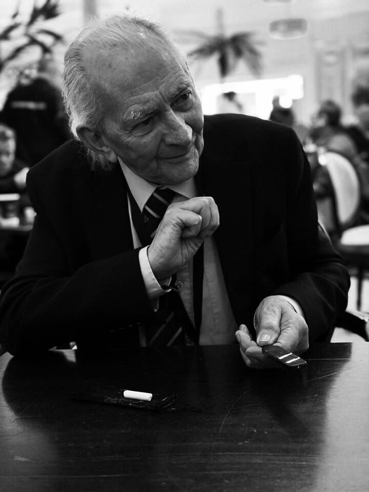 Black and white close-up portrait during table-side card magic